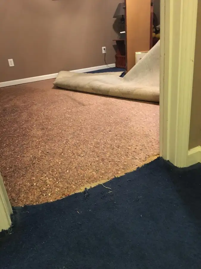 Carpet pad removal revealing water damage during Water Mitigation Services in Slidell